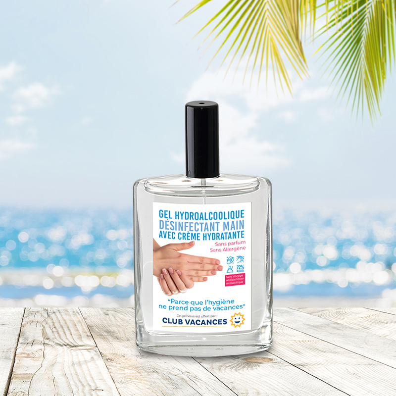 Gel hydroalcoolique publicitaire  en spray avec etiquette personnalisee posé sur une table